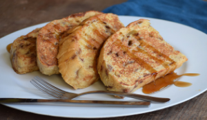 photo of French toast made with Cinnamon Chip Bread on a plate with a fork