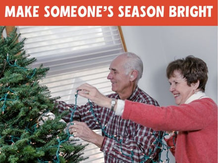 Photo of decorating a tree with text overlay that says Make Someone's Season Bright