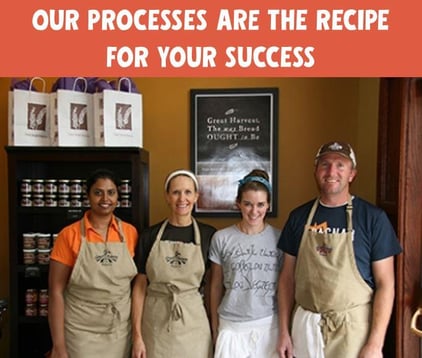 4 bakery trainees with aprons in a photo